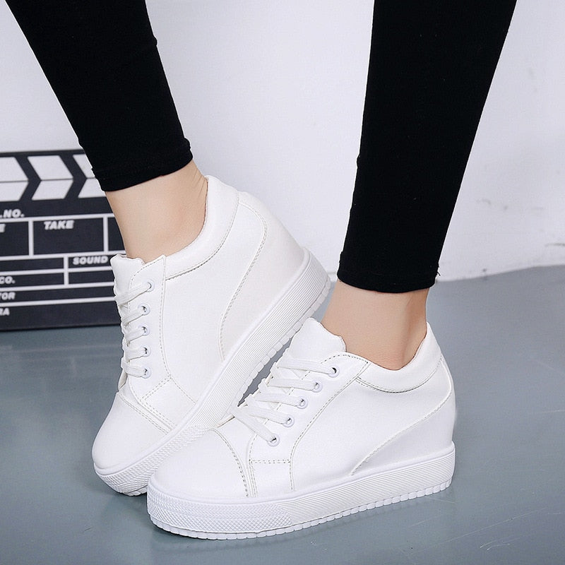 Stylish women's lace-up wedge platform sneakers. Comfortable height increasing casual shoes, perfect for urban everyday wear.