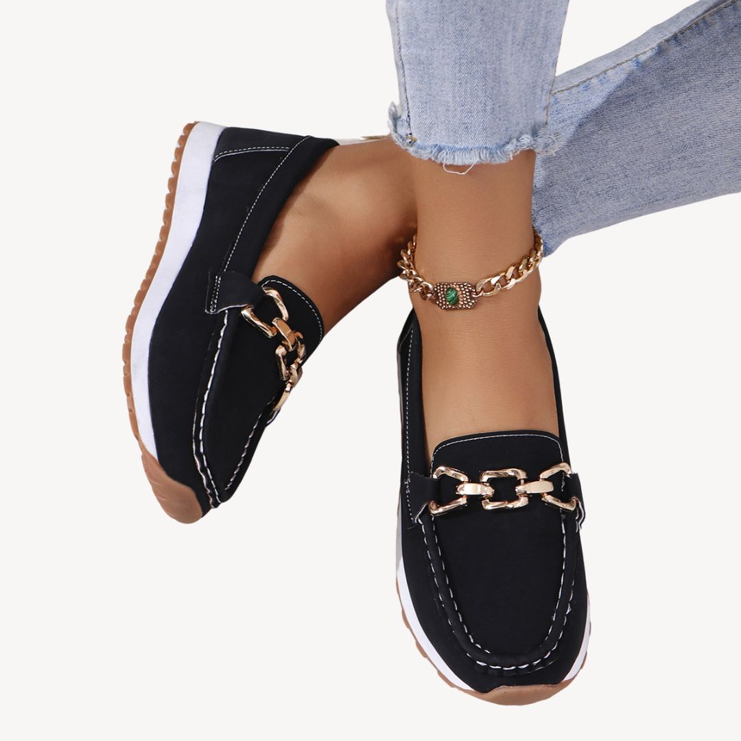 Stylish women's orthopedic loafers with elegant gold chain detail, offering comfortable arch support for everyday wear.