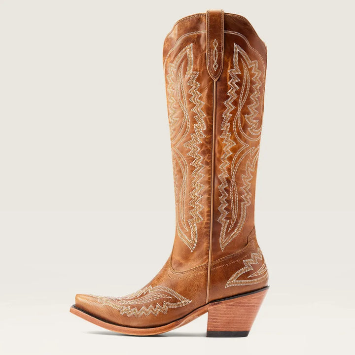Women's patterned tall boots with stacked heel, paired with a dress. Stylish all-season fashion boots.