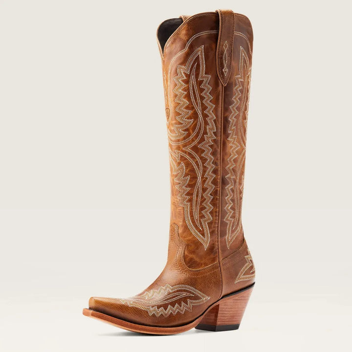 Elegant women's patterned knee-high boots with stacked heel, worn with jeans. Casual & fashionable zip boots.