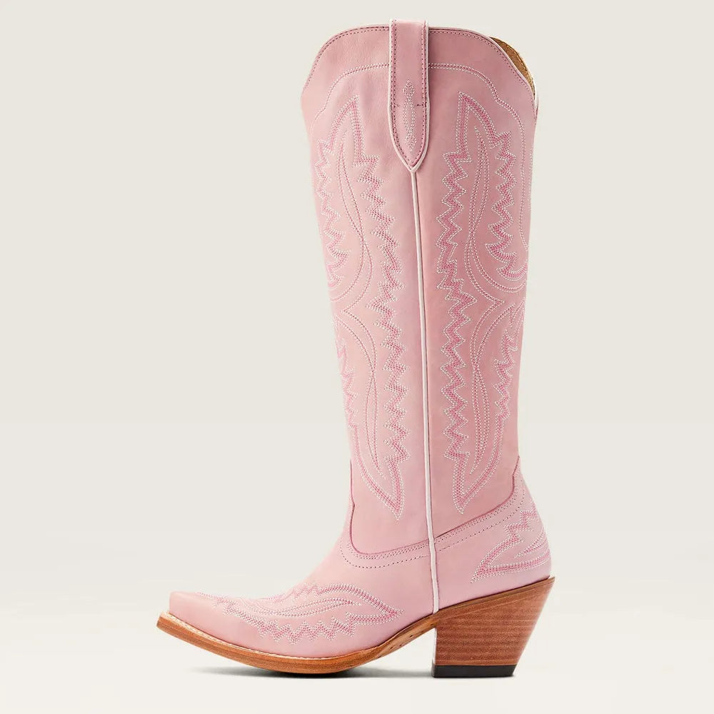 Women's patterned zip tall boots worn by model, full length. Features stacked heel, pointed toe, elegant style.