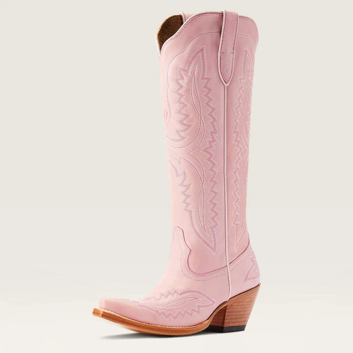 Casual women's patterned knee-high boots with stacked heel, worn by model sitting. Stylish zip boots.