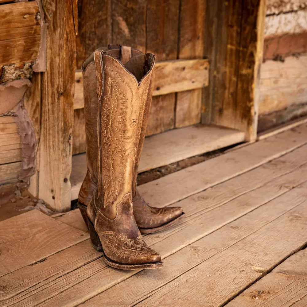 Detail of durable zipper on women's patterned tall boots. Fashionable design with comfortable stacked heel.
