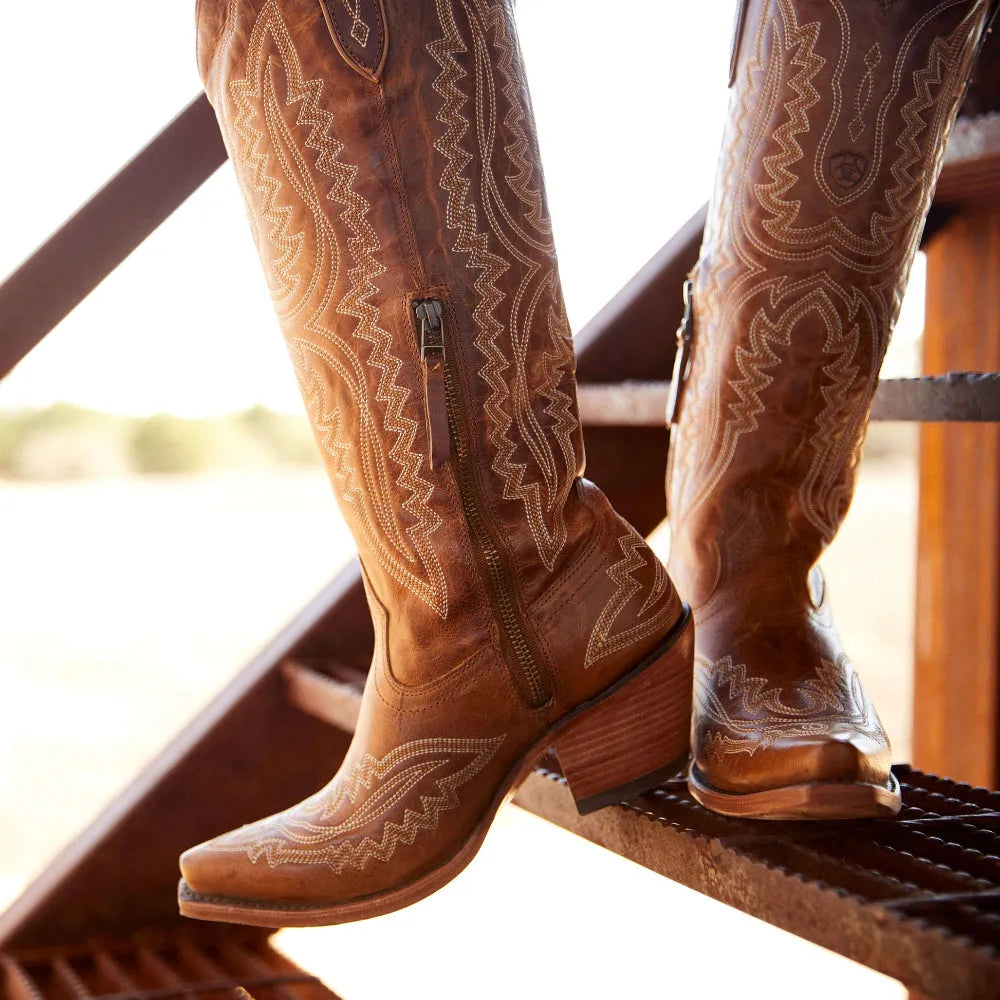 Stacked heel detail on elegant women's patterned tall boots. Features a comfortable height and stylish design.
