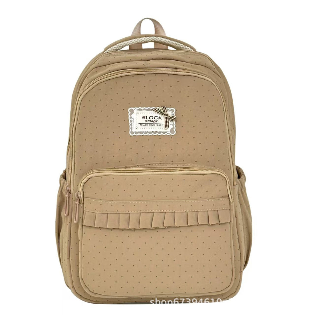Fashionable polka dot backpack with playful ruffles. A stylish women's bag perfect for school or casual outings.