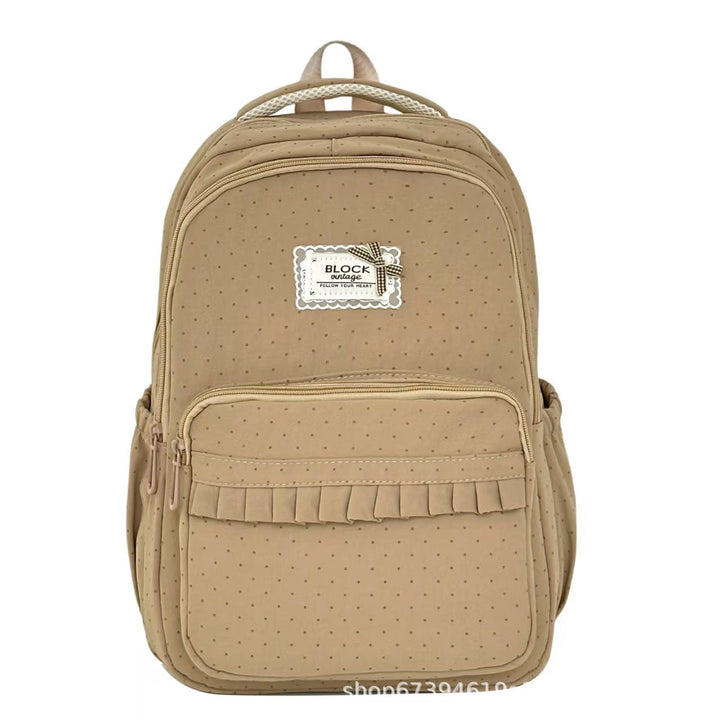 Fashionable polka dot backpack with playful ruffles. A stylish women's bag perfect for school or casual outings.