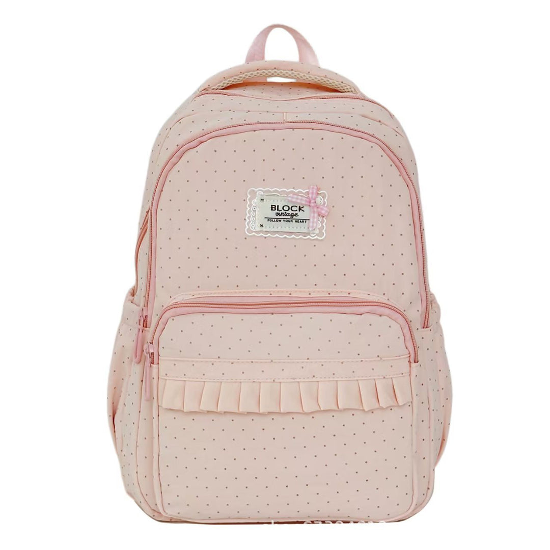 Chic ruffled women's backpack featuring a classic polka dot pattern. A stylish fashion accessory for any casual outfit.