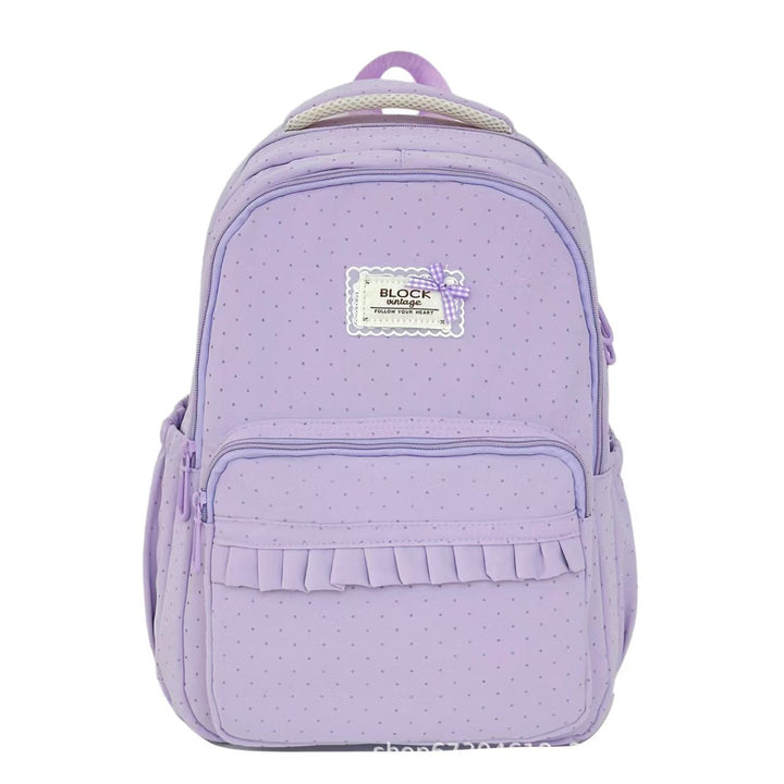 Front view of a women's polka dot ruffled backpack, highlighting chic design, sturdy straps, and practical storage.