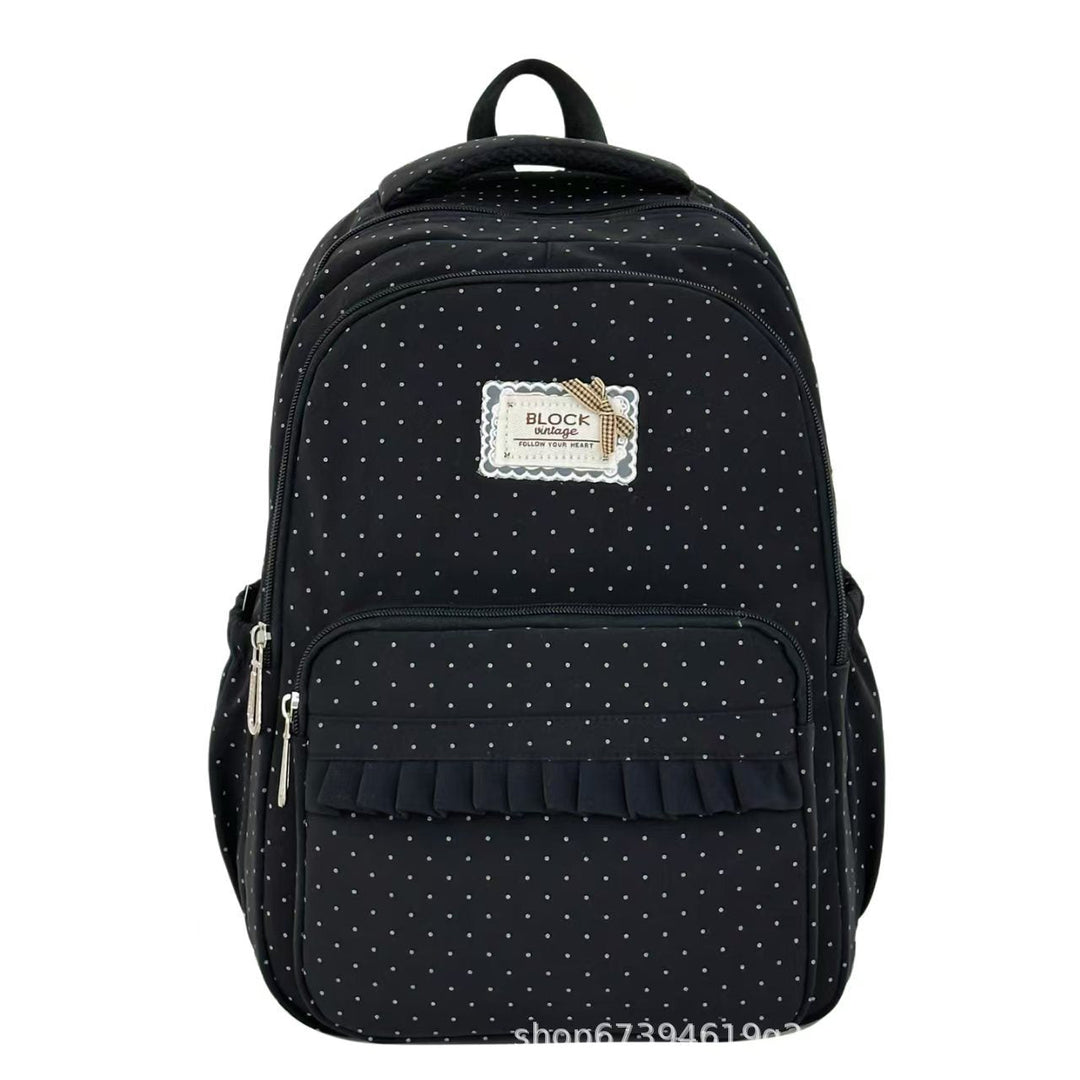 Back of a women's polka dot ruffled backpack, featuring comfy adjustable straps & a spacious interior for travel or school.