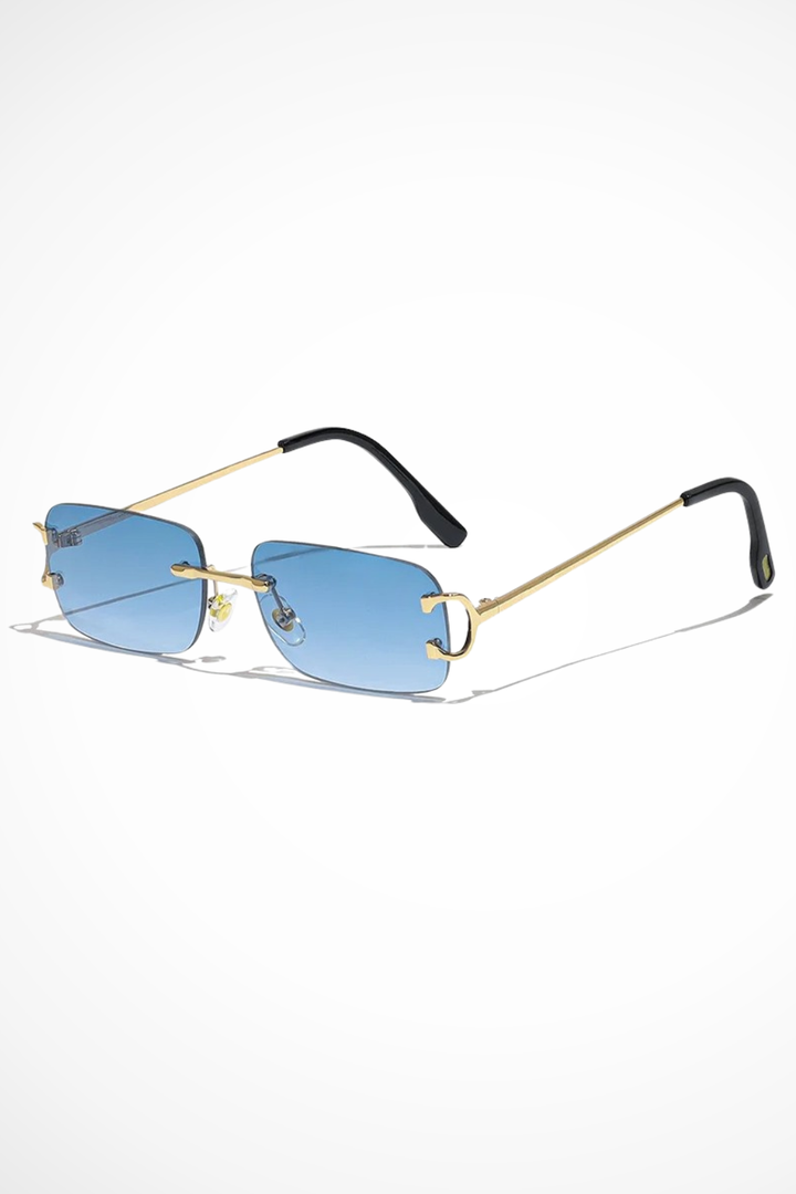 Close-up of women's rimless rectangular sunglasses with reflective tinted lenses and polished gold temple arms.