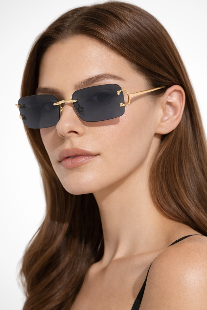 Women's rimless rectangle sunglasses, brown tinted lenses, polished gold metal frames, a fashionable eyewear piece.