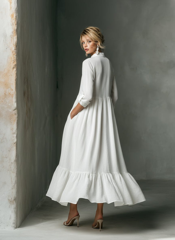 Detail shot of the ruffle hem and button-front on a women's versatile long sleeve maxi shirt dress.