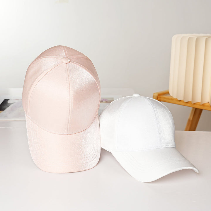 Black satin baseball cap for women, a versatile and sporty fashion accessory for any outfit.
