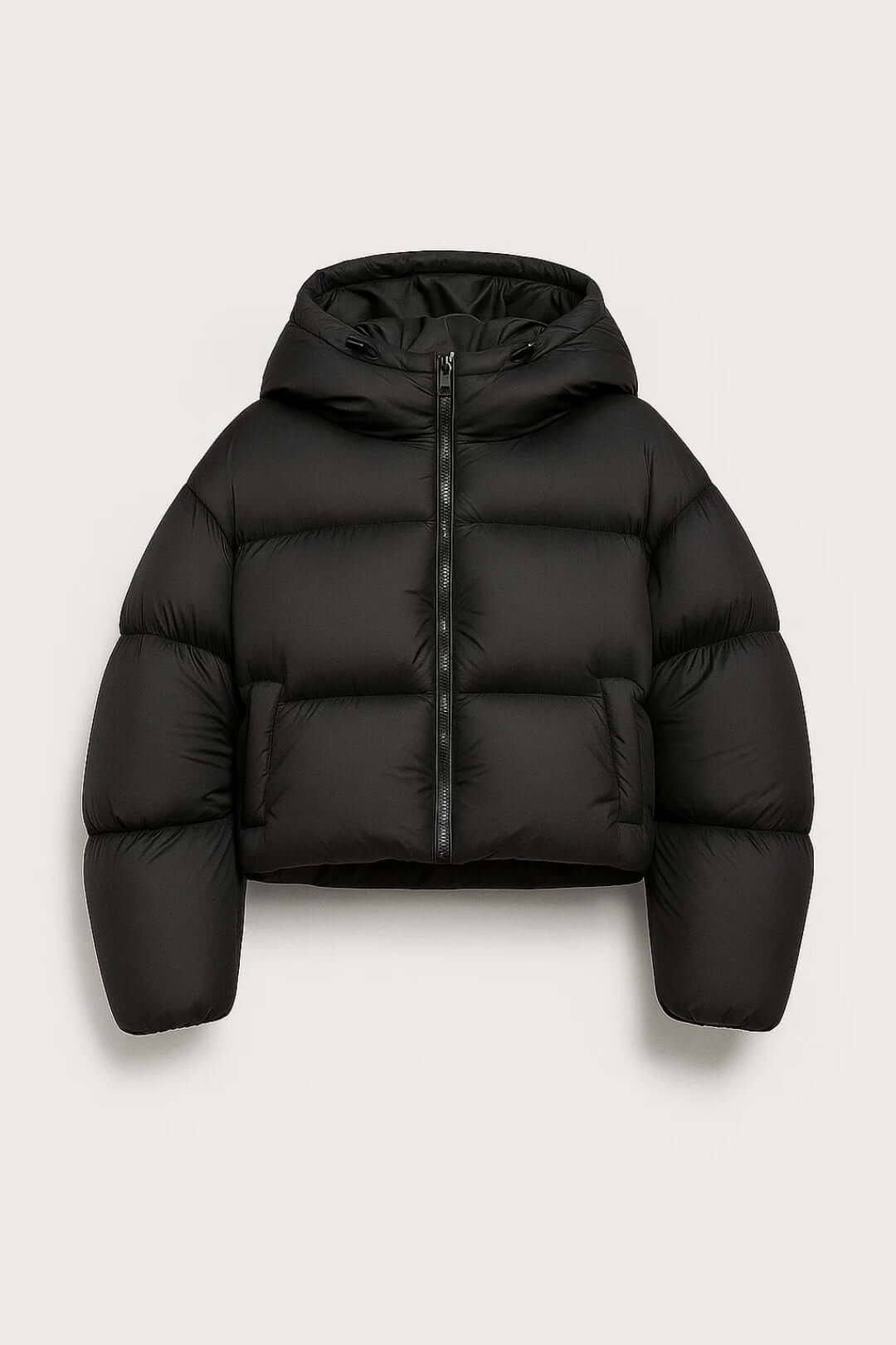 Stylish women's short puffer jacket with hood for warmth. Ideal casual winter outerwear.