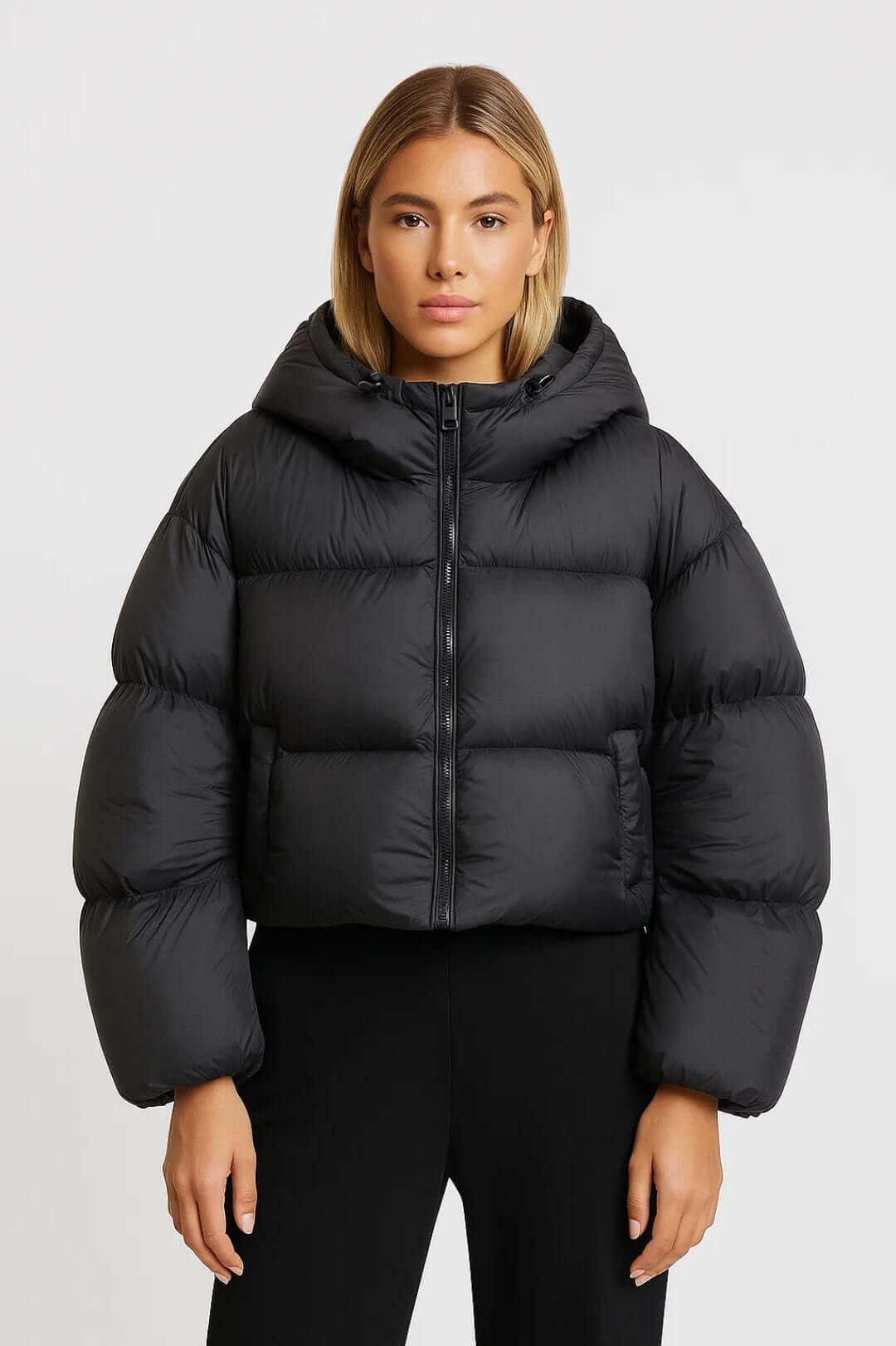 Warm hooded short puffer jacket for women. Fashionable winter outerwear perfect for casual style.