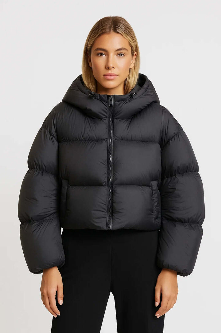 Warm hooded short puffer jacket for women. Fashionable winter outerwear perfect for casual style.