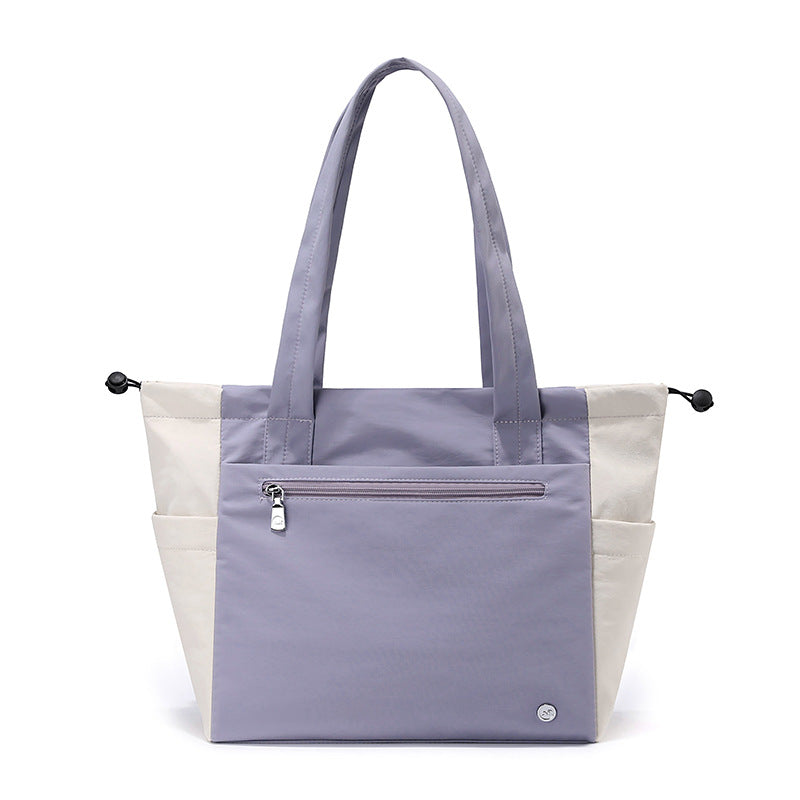 Multi-functional women's tote bag showing ample interior space for work essentials & travel items, durable.