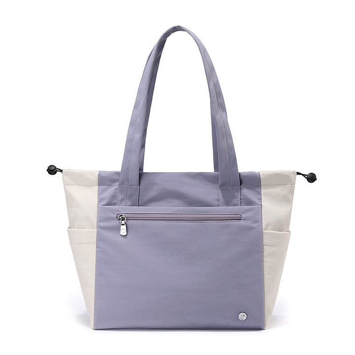 Multi-functional women's tote bag showing ample interior space for work essentials & travel items, durable.