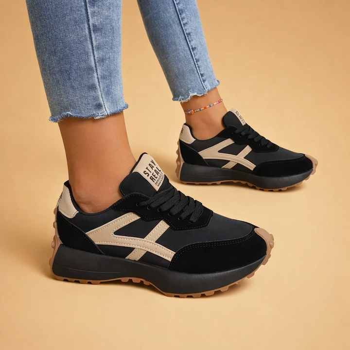 Woman wearing casual women's sneakers with jeans, showcasing their versatile urban style.