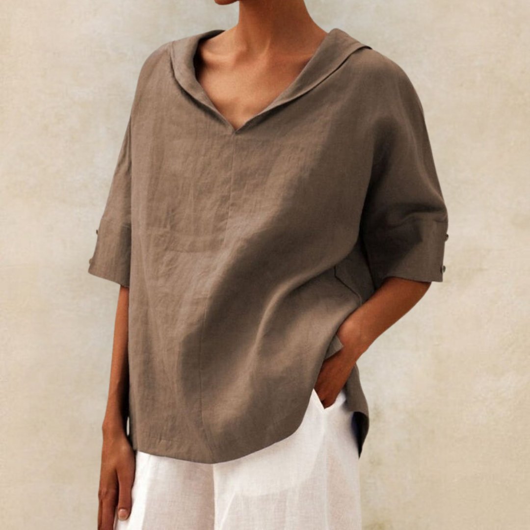 Fashionable women's V-neck blouse, relaxed fit, elbow sleeves. Ideal stylish top for work or casual outfits.