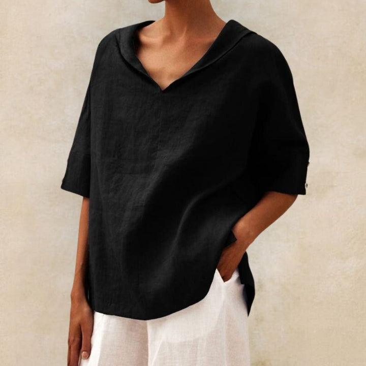 Comfortable women's V-neck blouse with a relaxed fit and elbow sleeves, offering a stylish look for casual wear.