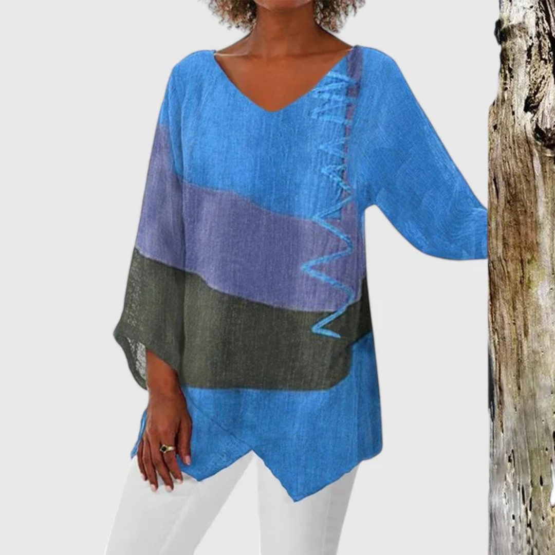 Elegant women's V-neck tunic with expressive artistic print. Casual, comfortable, and fashion-forward asymmetrical design.