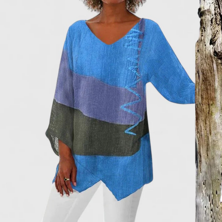 Elegant women's V-neck tunic with expressive artistic print. Casual, comfortable, and fashion-forward asymmetrical design.