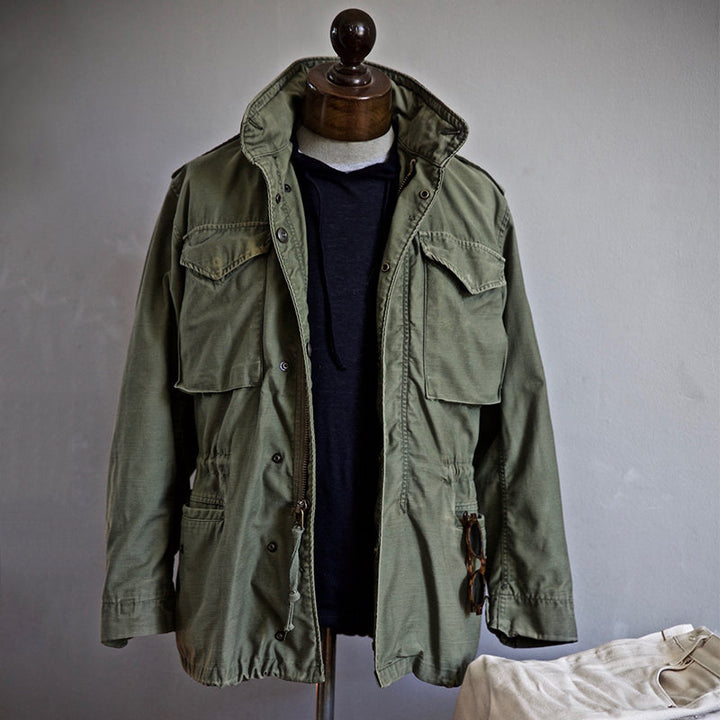 Durable women's military jacket with a hidden hood for versatile all-weather outdoor protection and style.