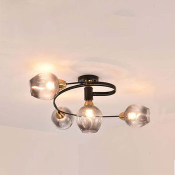 Sculptural gold Tavin flush mount light, modern ceiling fixture for stylish bedroom lighting.