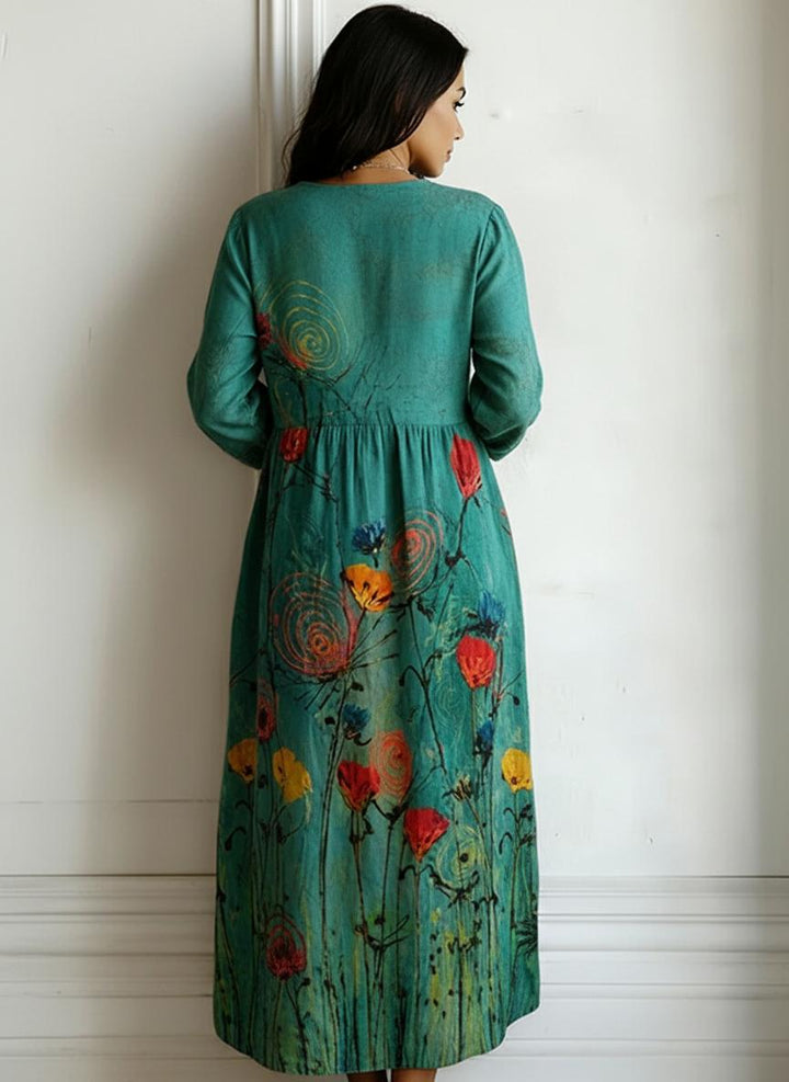 Plus size teal bohemian maxi dress showcasing an artistic floral pattern and v-neck design.