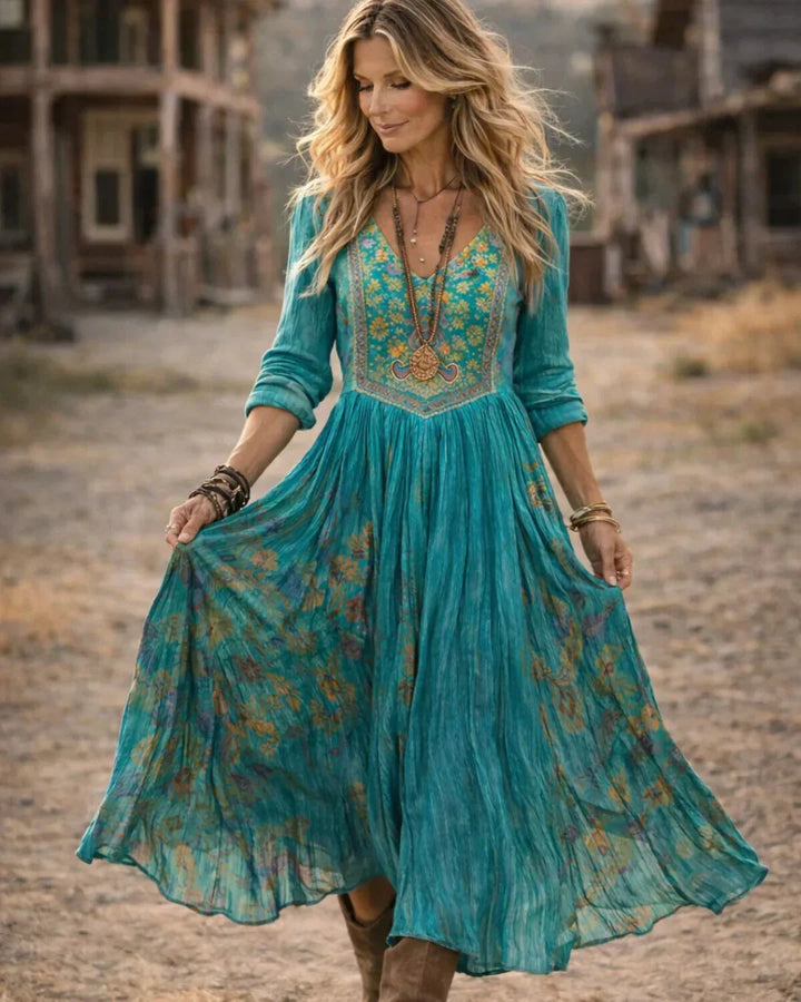 Beautiful embroidered boho maxi dress for women in teal, with stylish V-neck and long sleeves, showcasing bohemian charm.