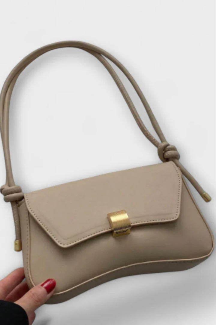 Elegant beige minimalist shoulder bag for women, featuring a chic gold clasp & adjustable strap.