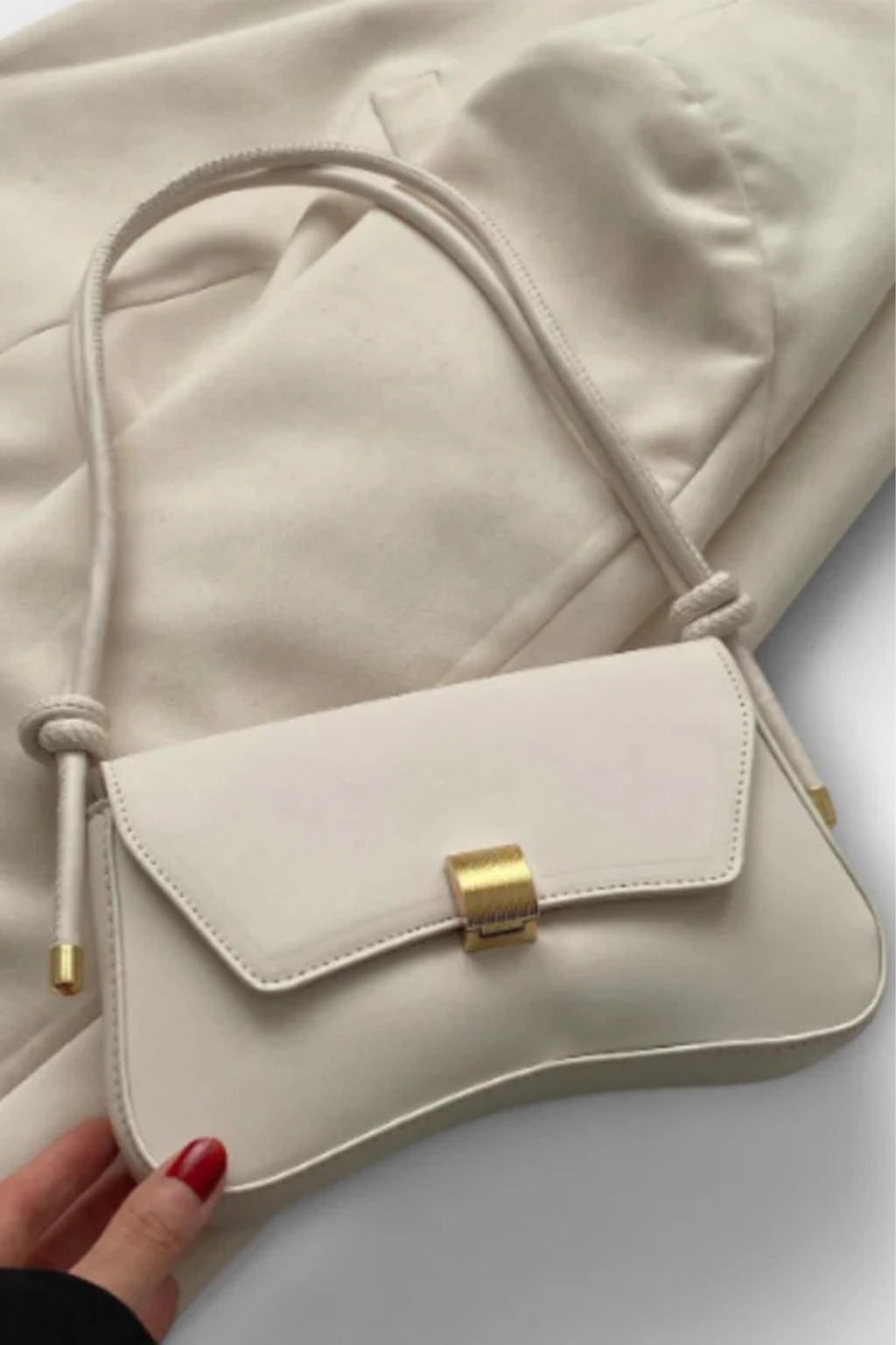 Compact women's minimalist shoulder bag with an elegant flap design and striking gold clasp. Perfect for everyday.