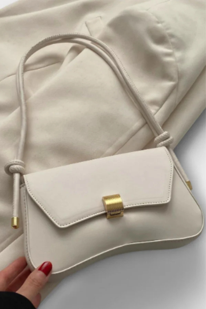 Compact women's minimalist shoulder bag with an elegant flap design and striking gold clasp. Perfect for everyday.