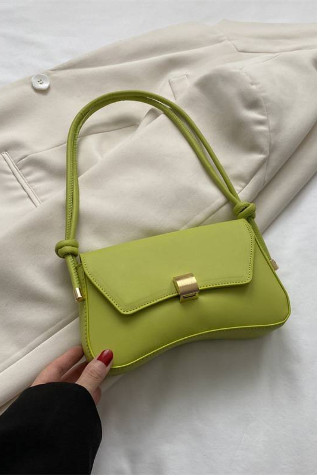 Chic beige compact shoulder bag for women. Minimalist flap design with a standout gold clasp & adjustable strap.