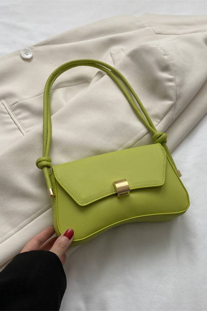 Chic beige compact shoulder bag for women. Minimalist flap design with a standout gold clasp & adjustable strap.
