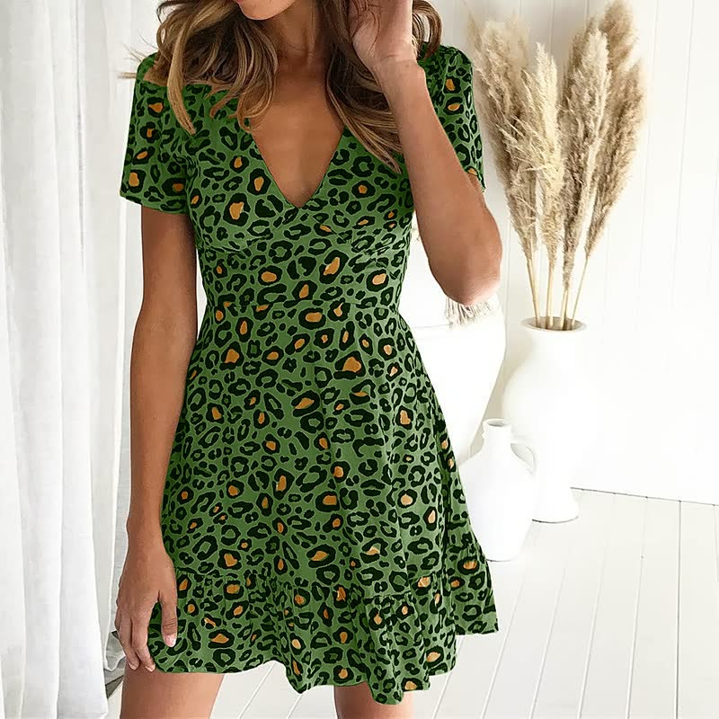 Stylish women's short sleeve leopard print mini dress with V-neck & ruffle hem. Trendy, casual chic summer outfit.