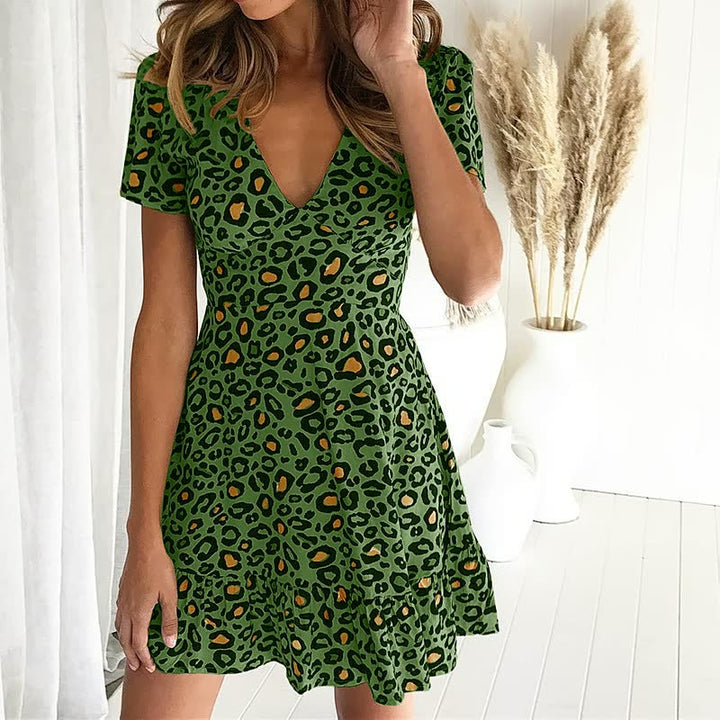 Stylish women's short sleeve leopard print mini dress with V-neck & ruffle hem. Trendy, casual chic summer outfit.