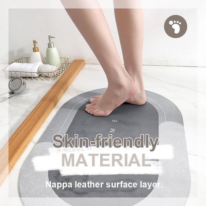 Gray oval bath mat, highly absorbent and non-slip for maximum safety.