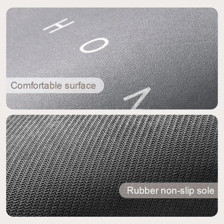 Soft, absorbent bath mat in gray, provides a non-slip surface for safety.
