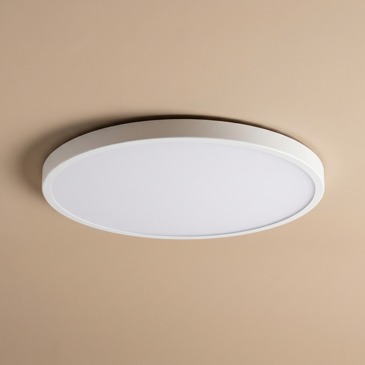 Stylish black trim round LED ceiling light, slim flush mount design, adding a sleek touch to any room.