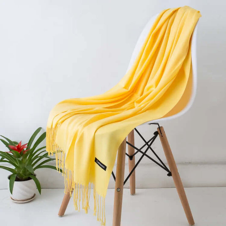 Hand feeling the plush, ultra-soft women's luxury scarf, highlighting its comfort.