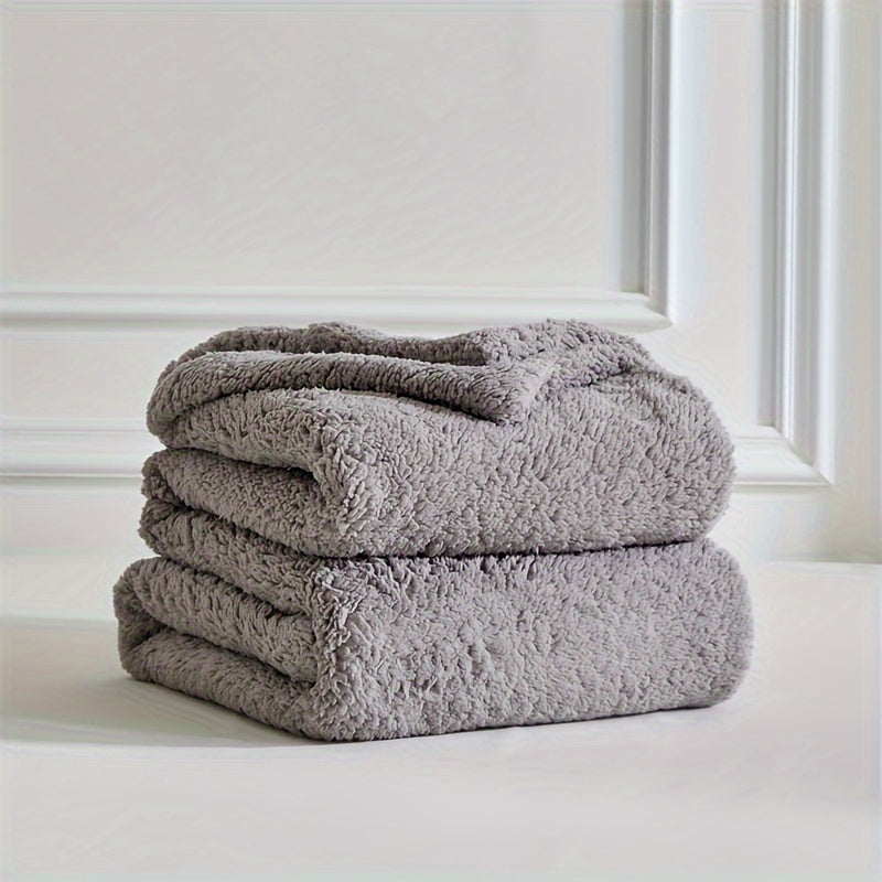 Soft polyester sherpa fleece blanket, a warm and cozy throw for comfortable home relaxation.