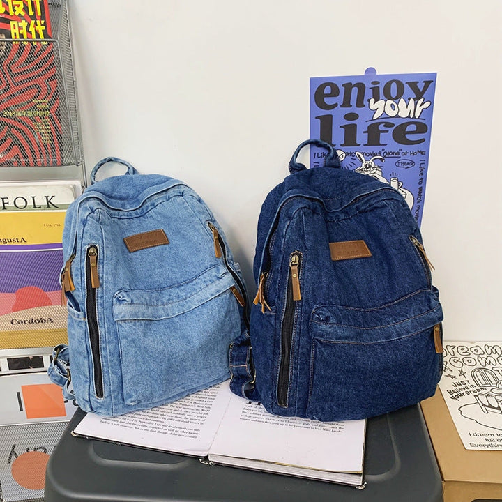 Dark blue denim school backpack, versatile for men & women, a durable and casual everyday bag for all ages.