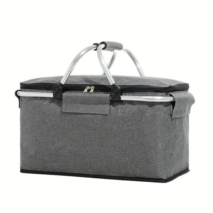 Person carrying a collapsible outdoor cooler basket for a picnic, filled with food & drinks.