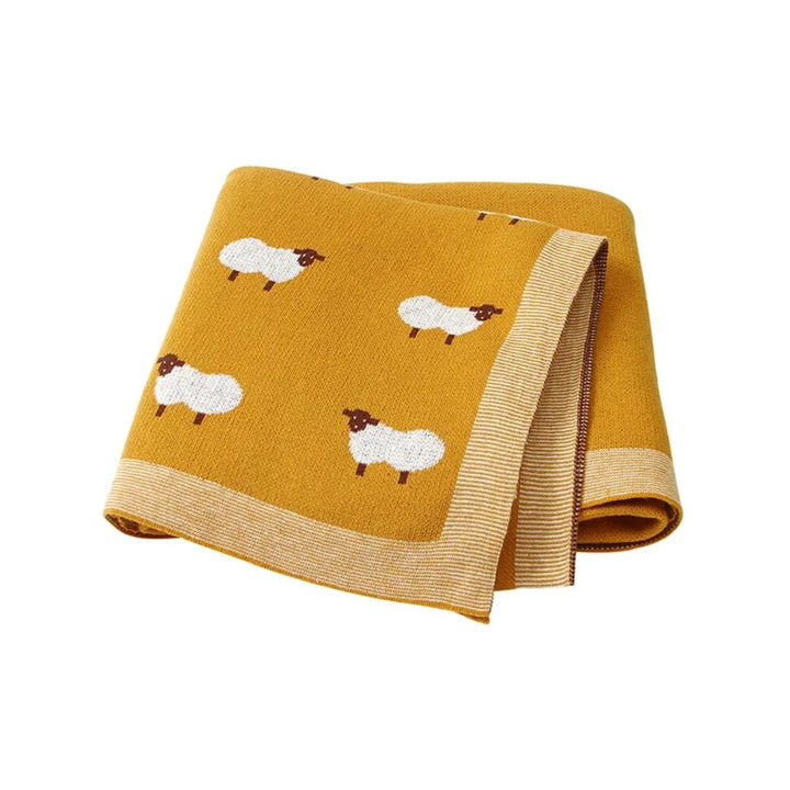 Newborn sleeping peacefully wrapped in a cozy, unisex cotton knit swaddle blanket.