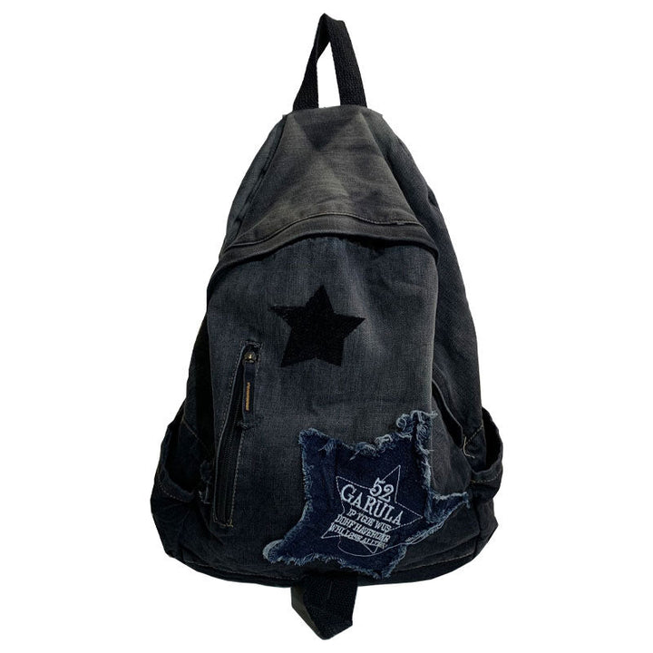Stylish unisex denim casual backpack featuring a unique star appliqué design. A trendy fashion accessory for students.