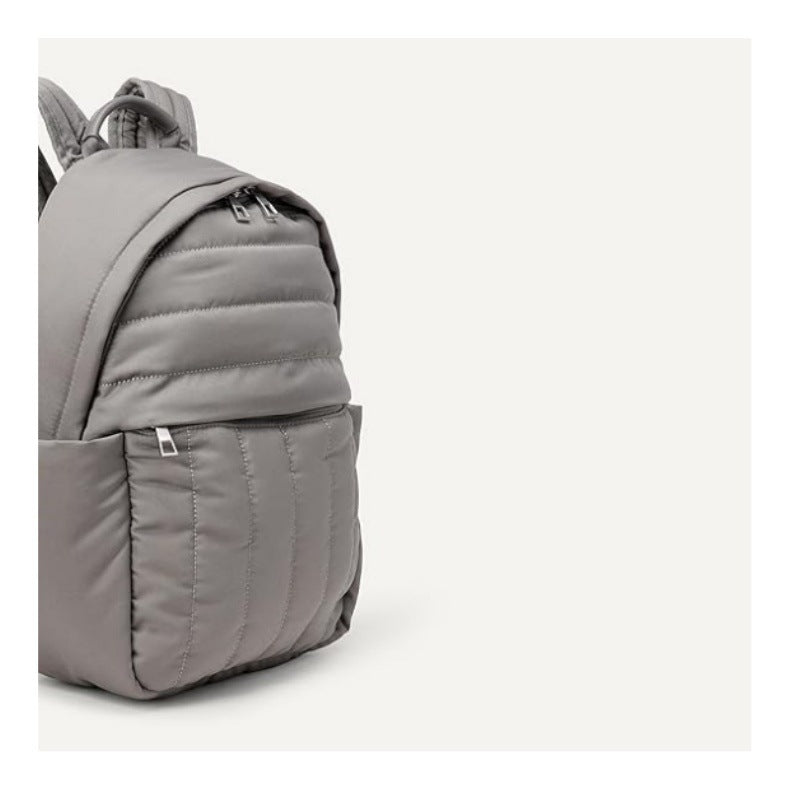 Back of a comfortable black ergonomic backpack, showcasing padded back panel & adjustable straps for support.