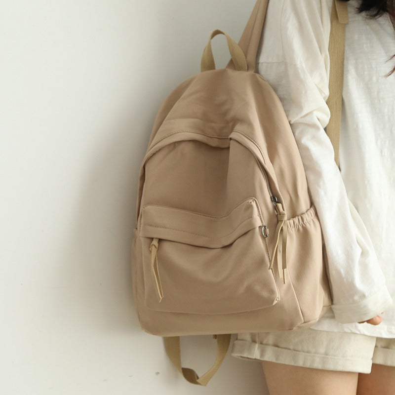 Stylish black unisex backpack for daily use, work, or travel. Features organized compartments & comfortable straps.