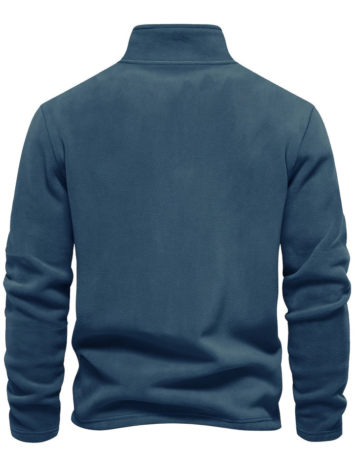 Soft fleece-lined unisex half-zip pullover, ensuring warmth and coziness on chilly days.
